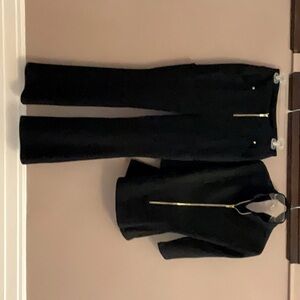 These designer scrubs are used and are black with black zippers and buttons!